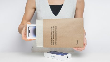 Person holding a new smartphone in packaging.